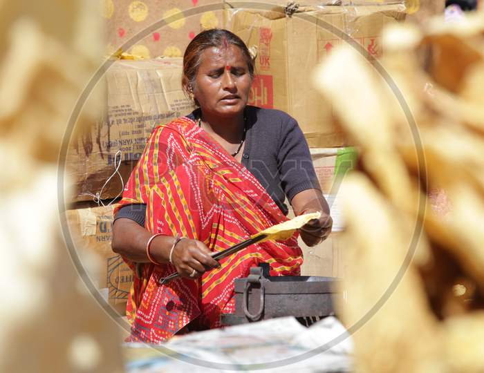 Rajasthani Woman Preparing Roti's in Shilpgram Fair, Udaipur, Rajasthan