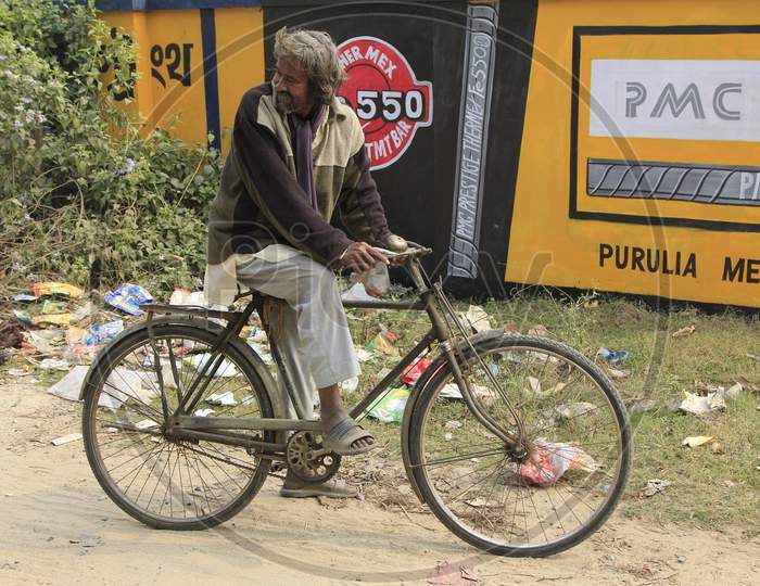 Indian Man on Bicycle in the Streets of Kolkata