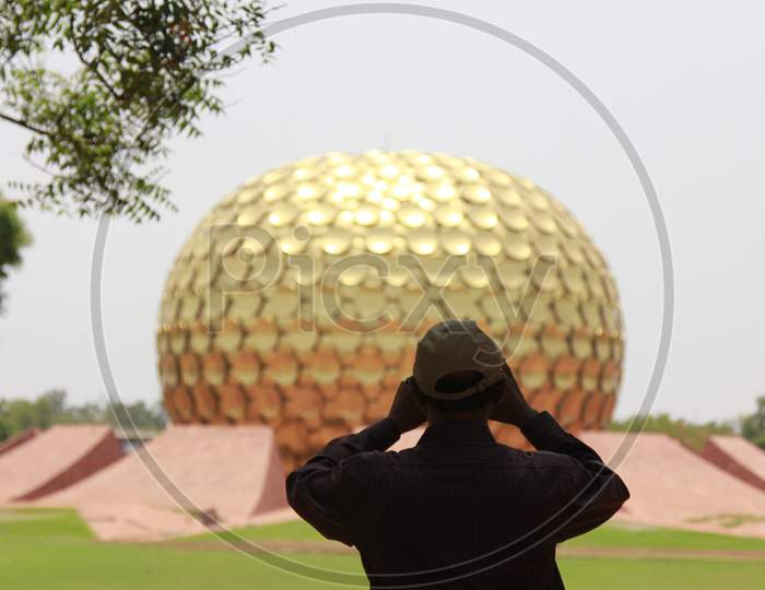 A Visitor Looking at Matrimandir, Auroville