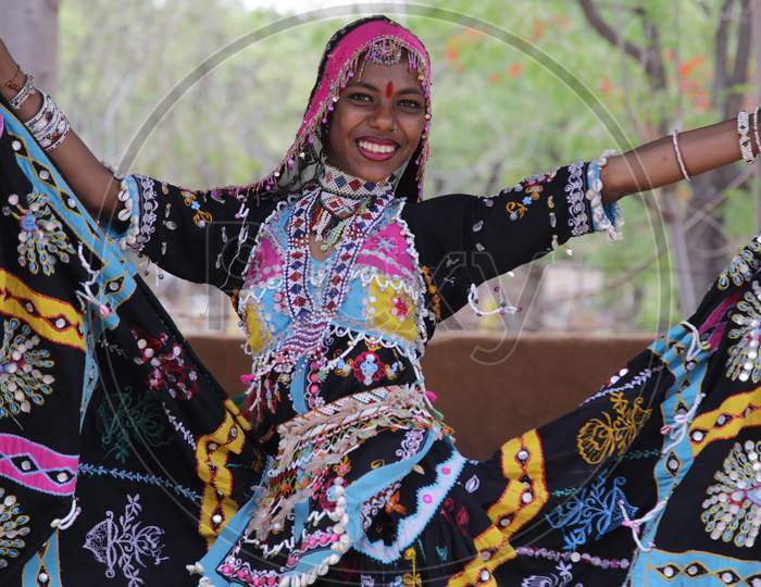Young Rajasthani Girl in Traditional Attire Dancing at Shilpgram Fair, Udaipur, Rajasthan