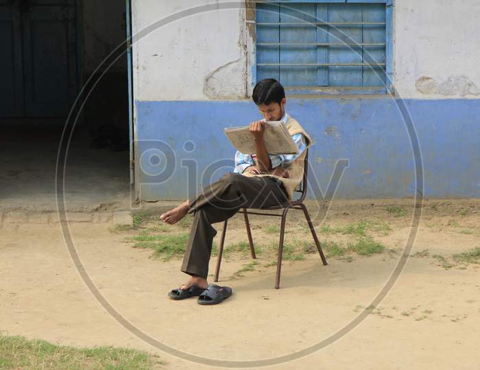 Young Indian Boy Reading Newspaper