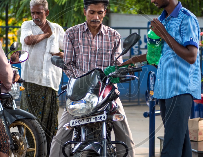 man filling petrol in the bike