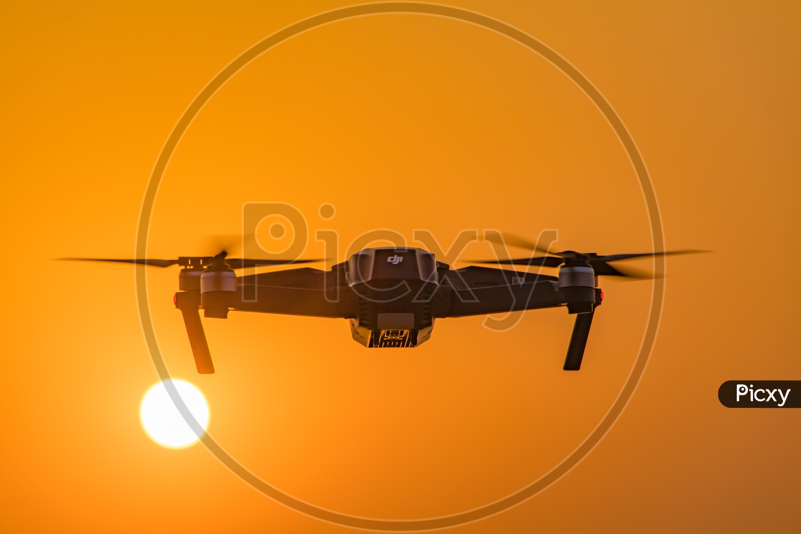 Closeup Shot of Drone Flying with Sun in Background