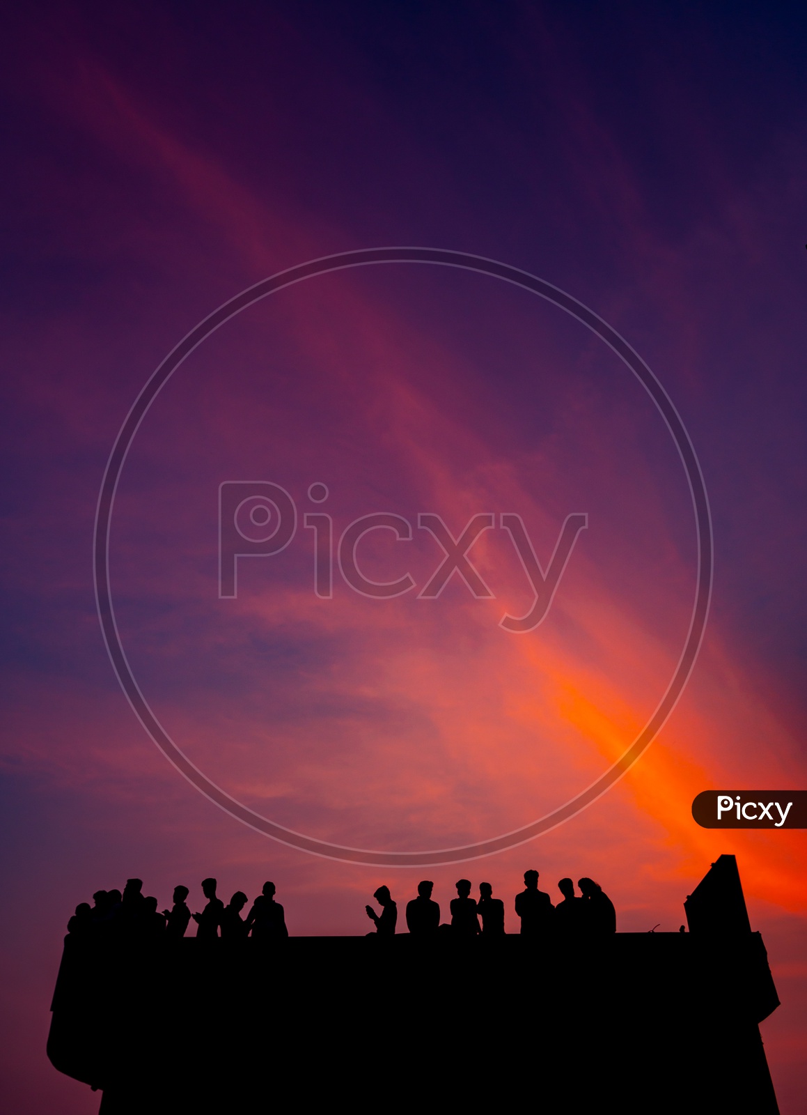 Silhouette of People with Dramatic colors in Background