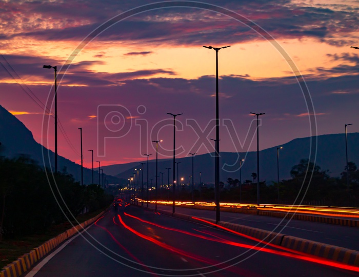 Long Exposure of Vehicles Moving On a Highway Road With Blue Hour Sunset Sky in Background