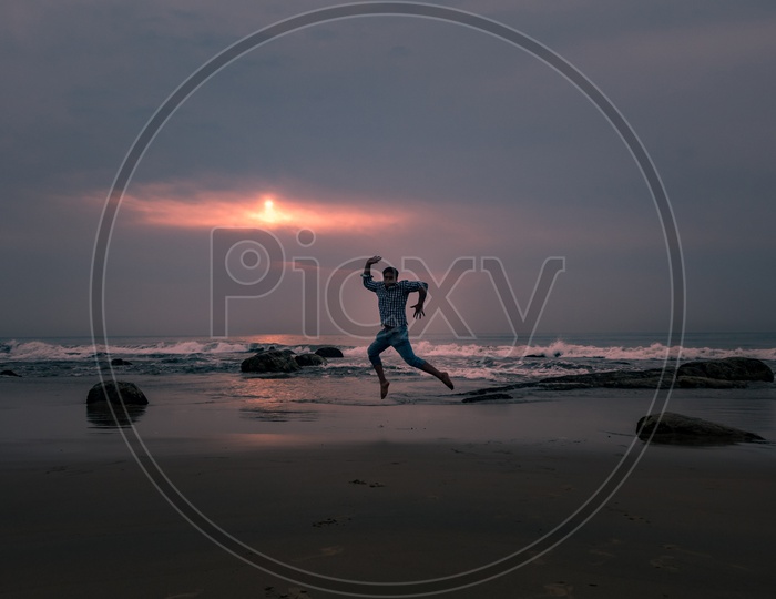 Man Jumping In Joy At a Beach
