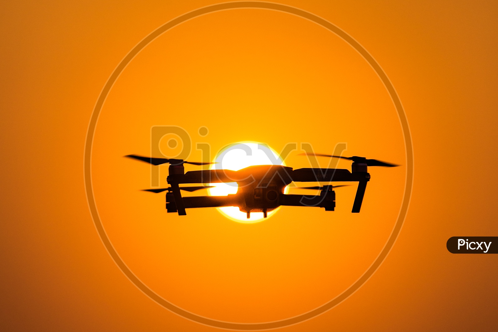 Closeup Shot of Drone Flying with Sun in Background