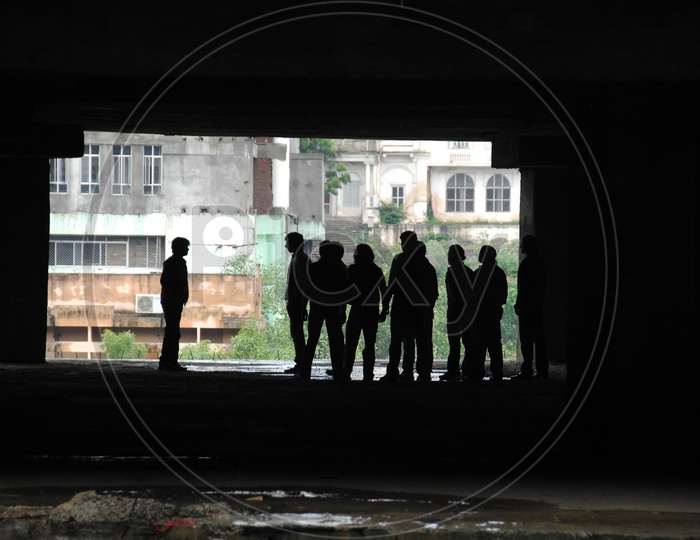 Silhouette of People in an Under Construction Building