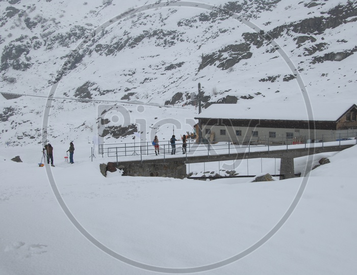 Film Crew Shooting In Snow filled Mountains In Switzerland