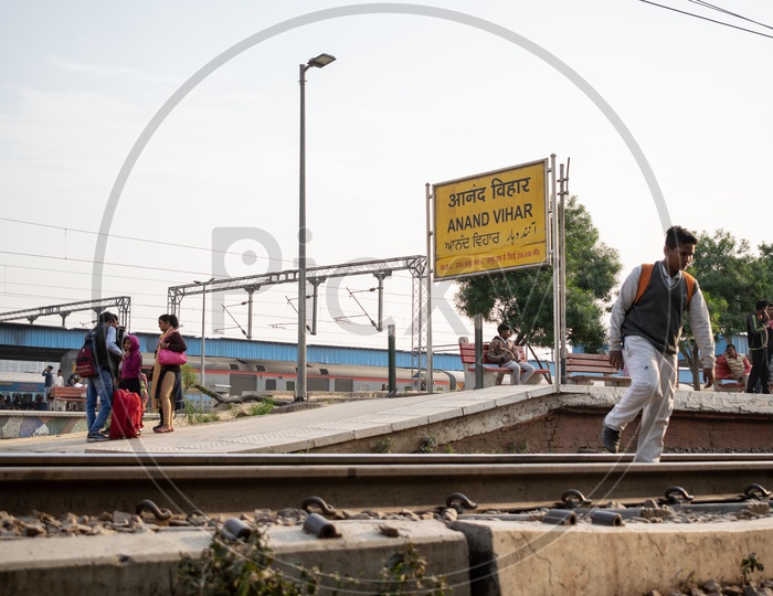 Passengers and a student crossing Railway Line at Anand Vihar Terminal railway station