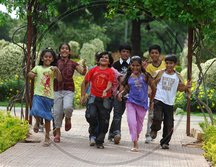 Group Of Children Running In Joy in a Park