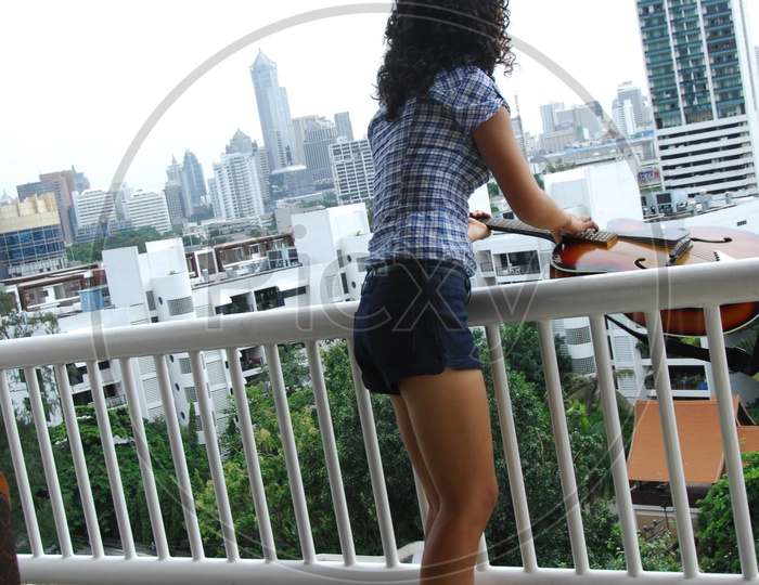 A Modern Girl Standing at a Balcony