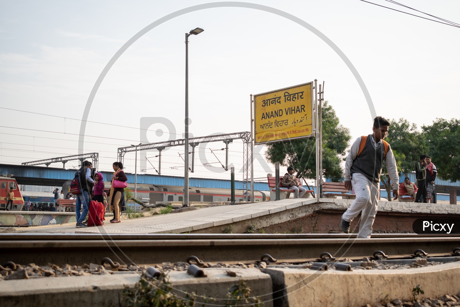 Passengers and a student crossing Railway Line at Anand Vihar Terminal railway station