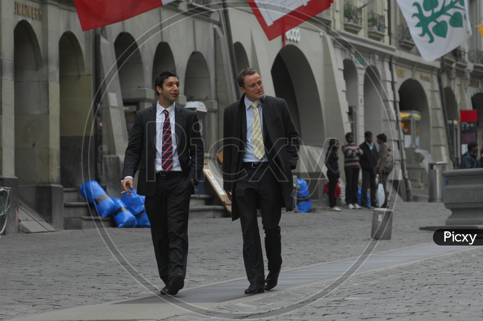 Two Young men walking wearing suits