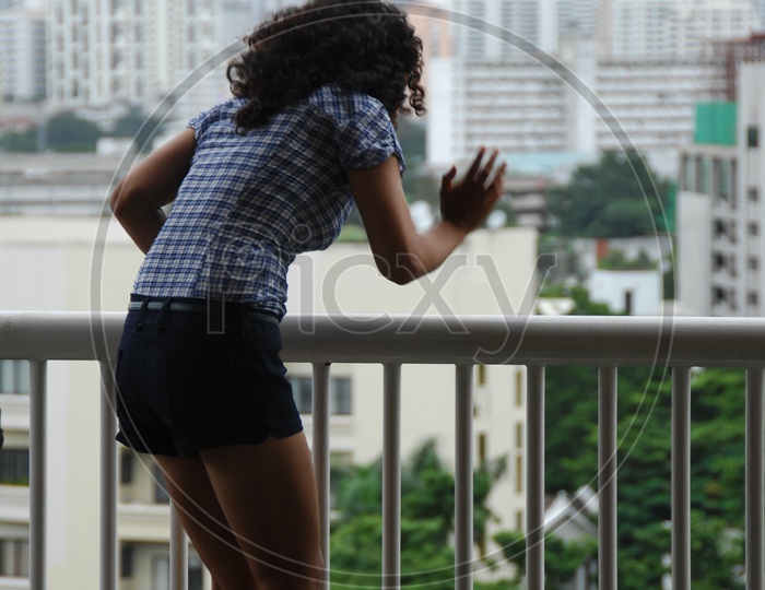 A Modern Girl Standing at a Balcony