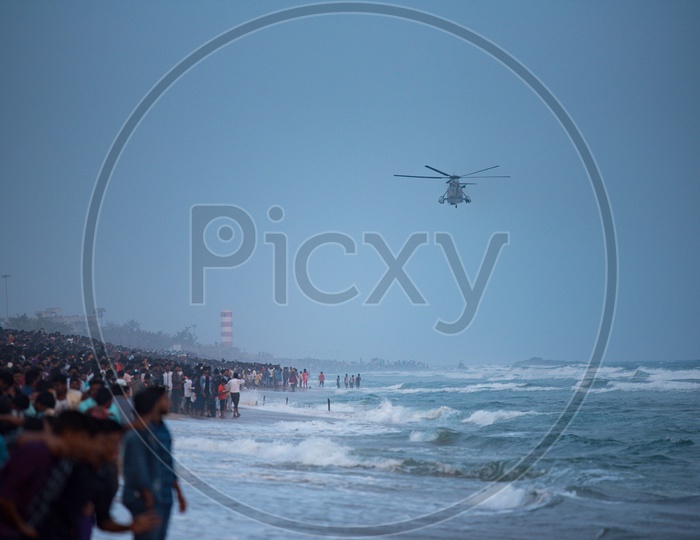 People watch Naval rescue demonstrations performed on Indian Navy Day celebrations in Visakhapatnam,December 4,2019