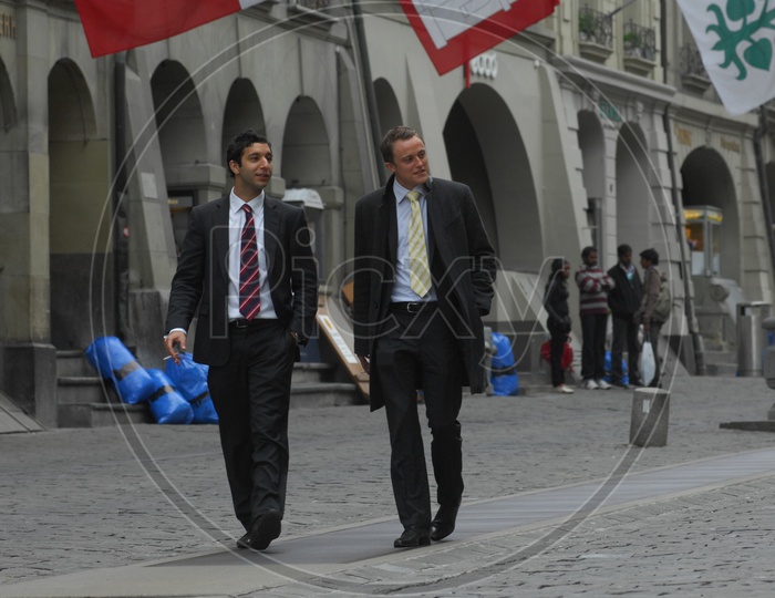 Two Young men walking wearing suits