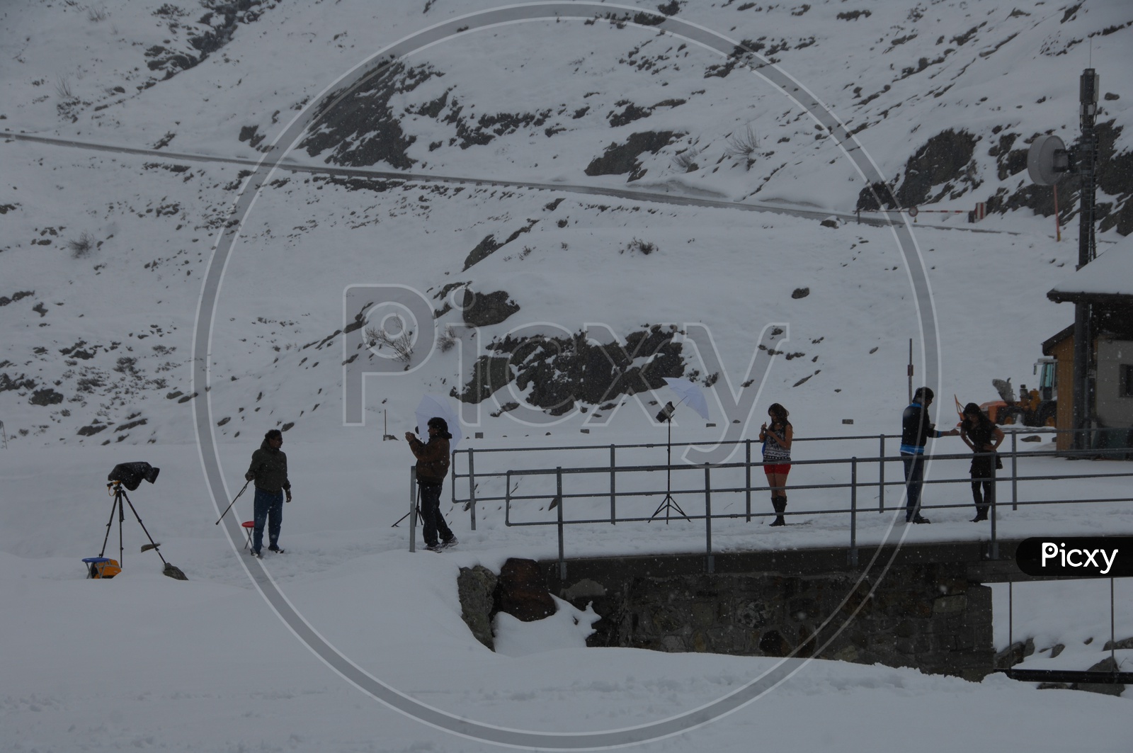 Film Crew Shooting In Snow filled MountainsIn Switzerland