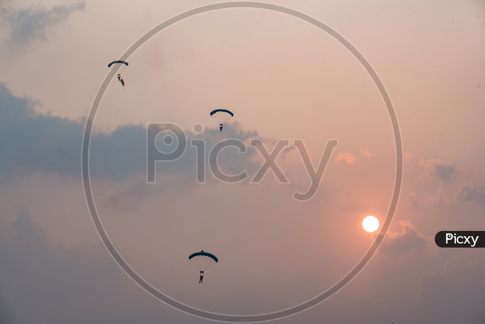 Indian Naval officers perform a paragliding stunt during Indian Navy Day celebrations, Visakhapatnam,December 4,2019