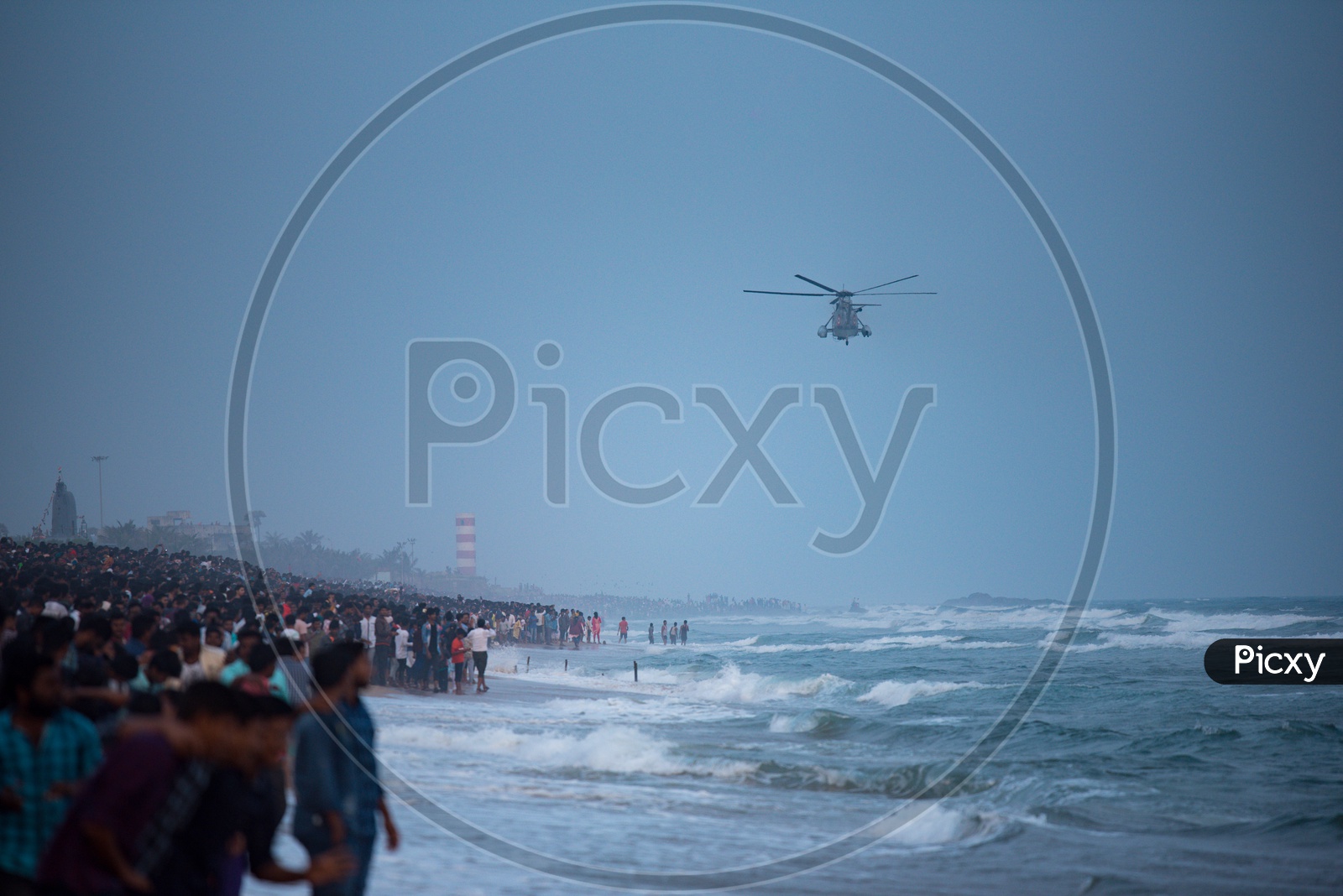 People watch Naval rescue demonstrations performed on Indian Navy Day celebrations in Visakhapatnam,December 4,2019