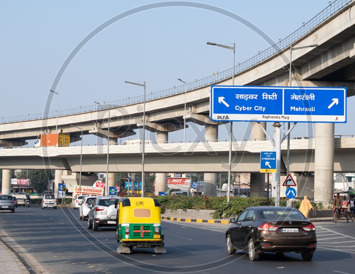 Rapid metro line in gurgaon passing over A road leading towards cyber city and Mehrauli