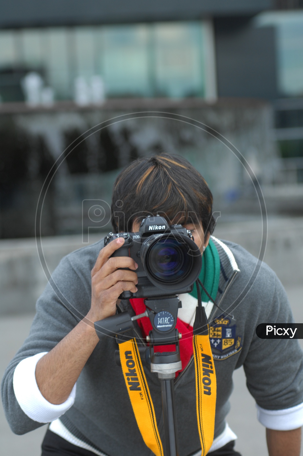 A Photographer With DSLR Camera in an Photo shoot