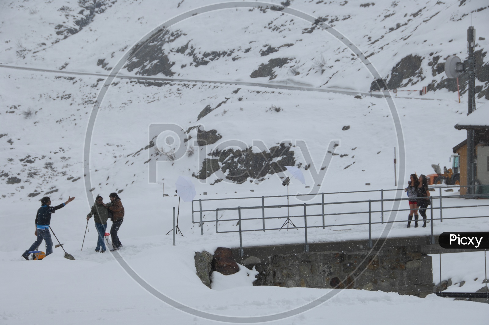 Film Crew Shooting In Snow filled Mountains In Switzerland
