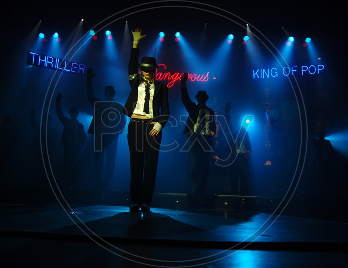 Silhouette Of a Dancer Making Micheal Jackson Postures on Stage With Neon Lights Background