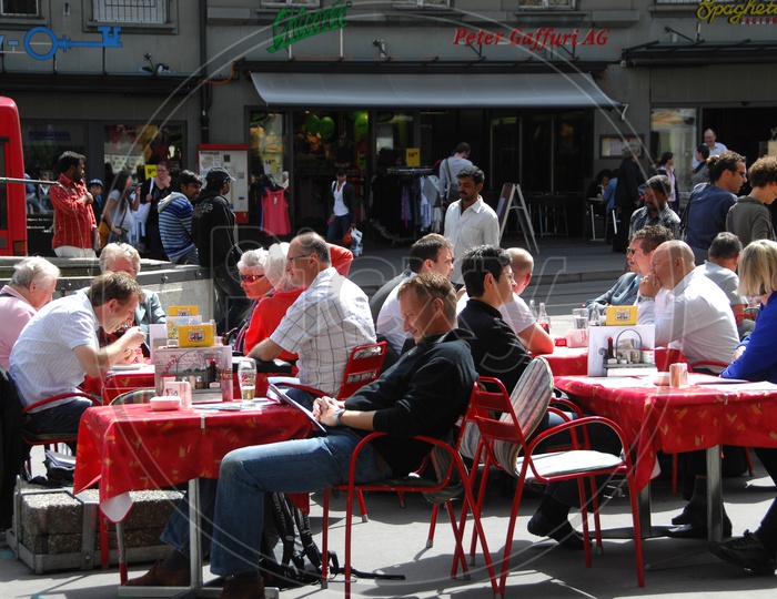 People Sitting on Dining Tables At a Food court in Switzerland