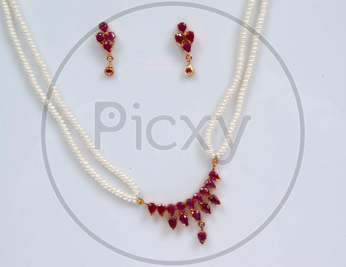 Pearl Necklace jewelery With Ear Rings on an isolated White Background
