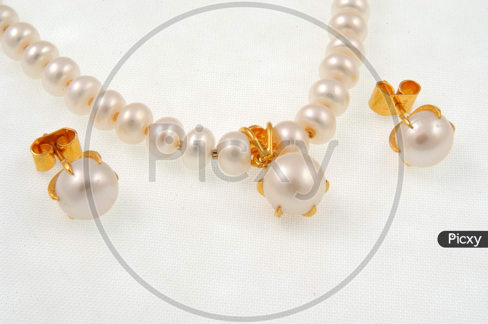 Diamond Necklace Jewelery  With White Pearls And Ear Rings  Over an Isolated White Background