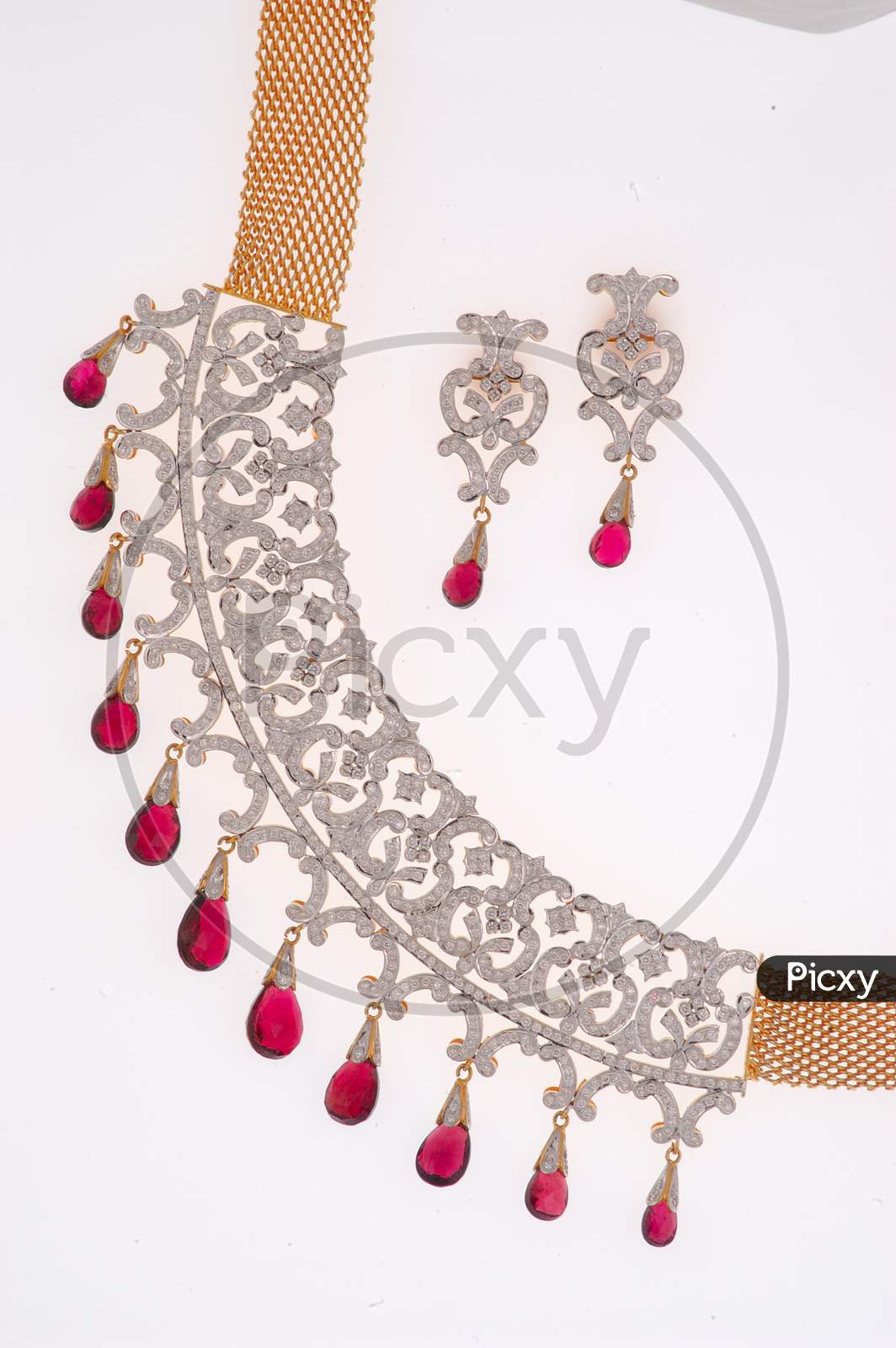 Diamond Necklace Jewelery With Ear Rings Over an Isolated White Background