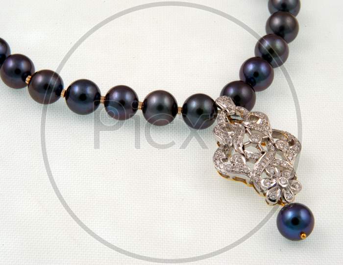 Diamond  Necklace Jewelery With Black Pearls Over an Isolated White Background