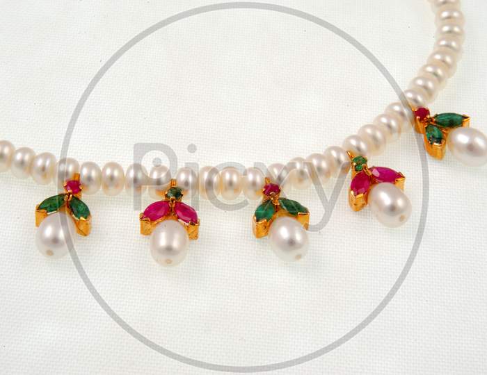 Necklace Jewelery  With White Pearls  Over an Isolated White Background