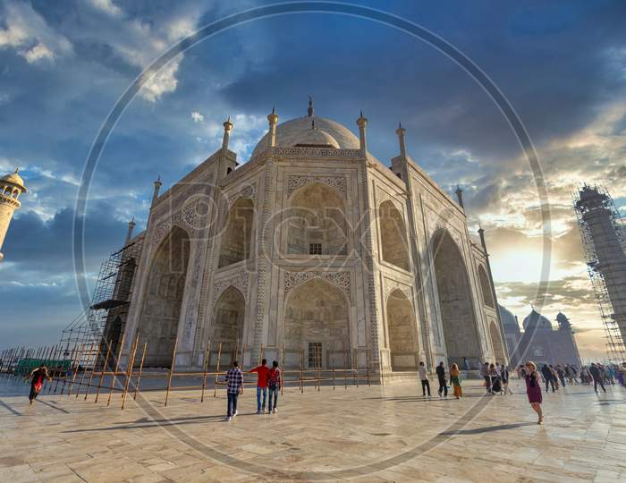 Taj Mahal With Tourists And Dark Clouds in Sky As a Background