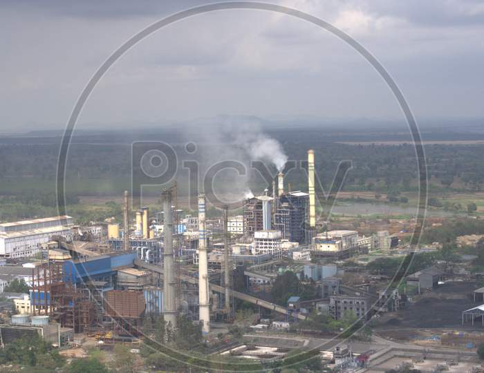 Aerial View Of an Industrial Plant With Exhaust Pipes And Smoke Clouds