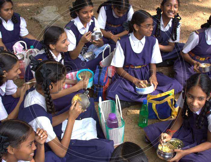 School Girls Having Lunch In a School