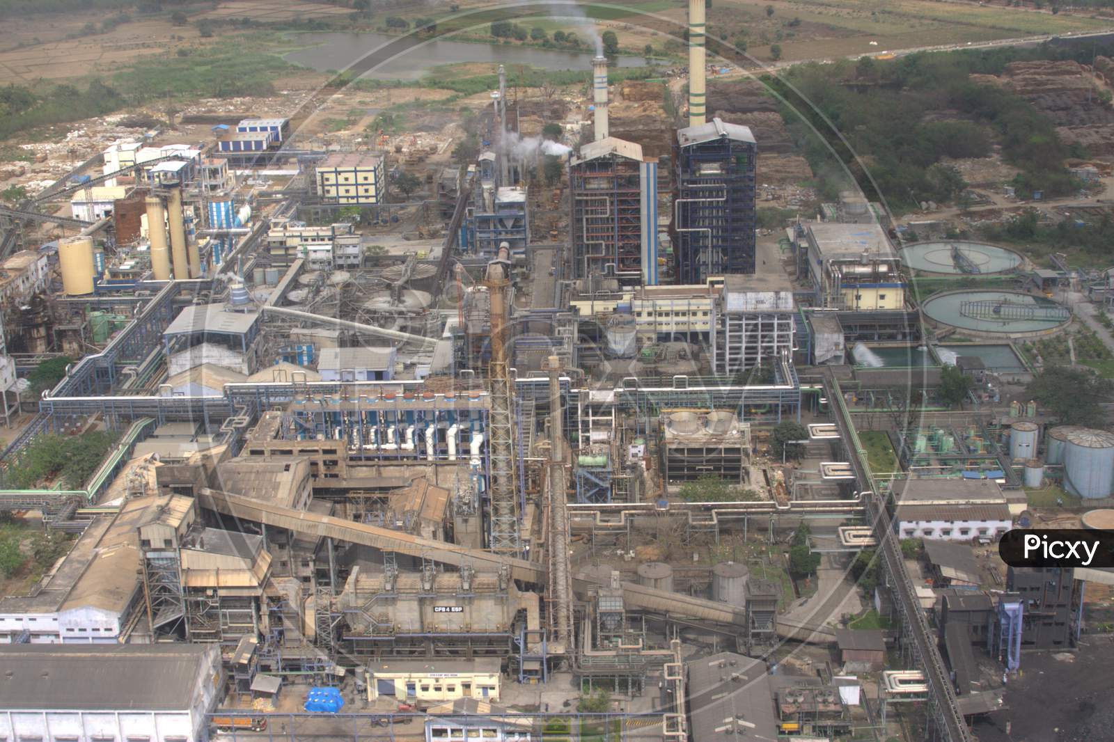 Aerial View Of an Industrial Plant With Exhaust Pipes And Smoke