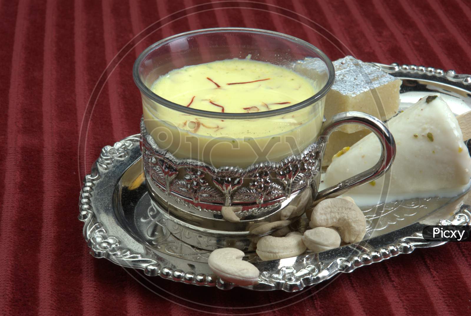 Indian Dessert Condensed Milk With Saffron and Nuts Topping Served in a Bowl