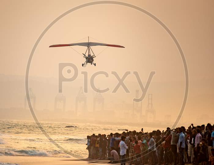 People Watching The Indian Navy Para gliders  Demonstration During Navy day Celebrations at RK Beach in Visakhapatanam
