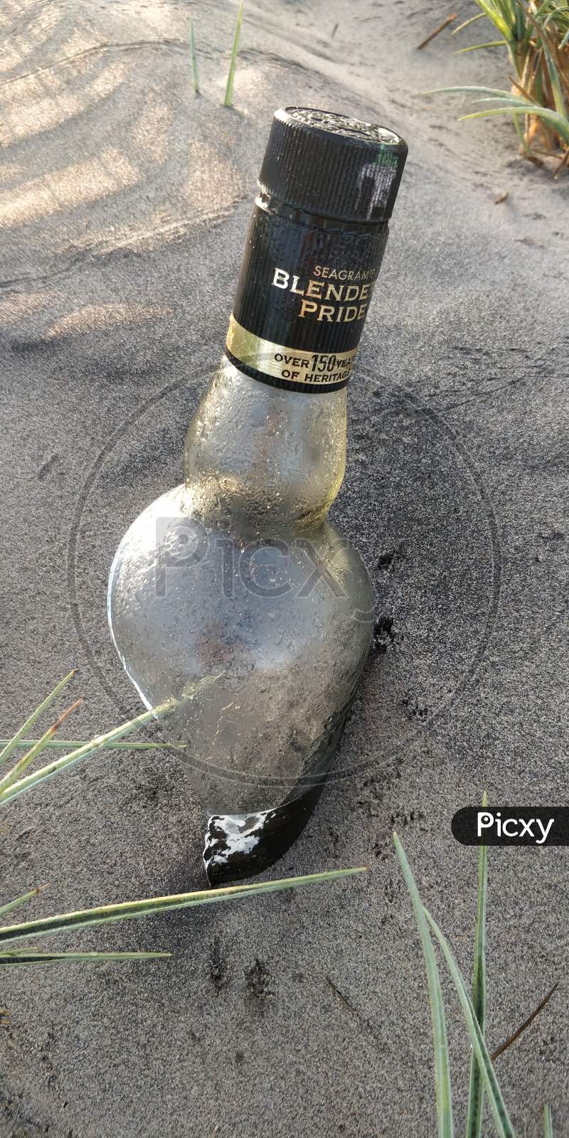 Drink bottle in sand at Perupalem Beach, Andhra Pradesh