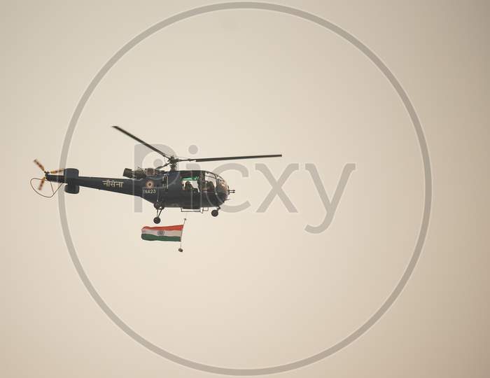 Indian Navy, Nau Sena light weight combat helicopter displays indian Flag during Navy Day celebrations in visakhapatnam