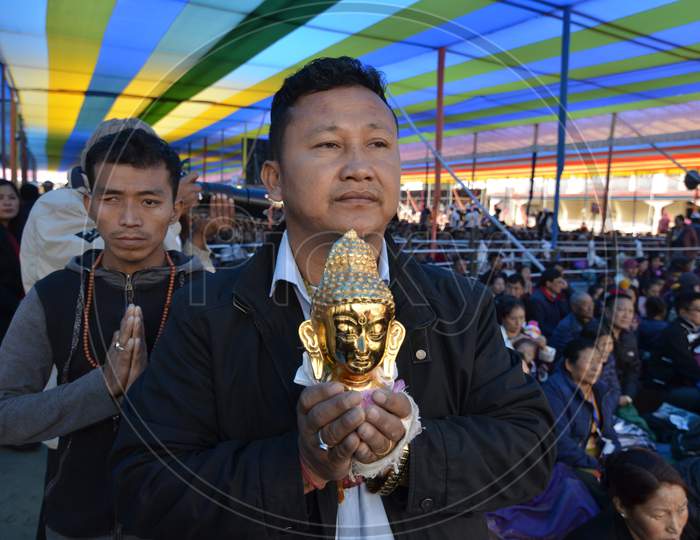 People wait for the arrival of Tibetan spiritual leader Dalai Lama at the Tawang Monastery,