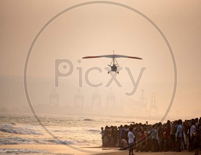 People Watching The Indian Navy Para gliders  Demonstration During Navy day Celebrations at Visakhapatanam