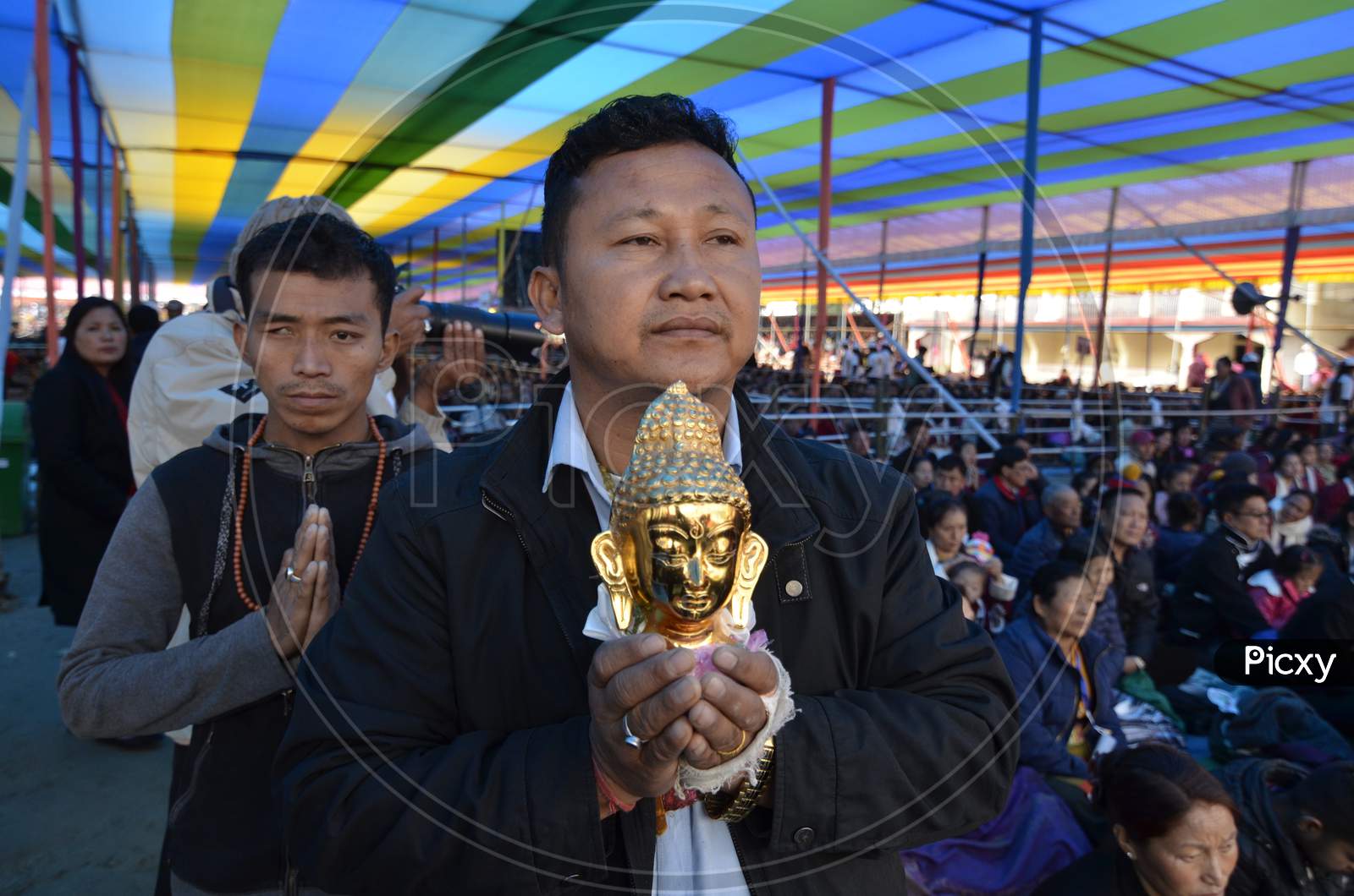 People wait for the arrival of Tibetan spiritual leader Dalai Lama at the Tawang Monastery,