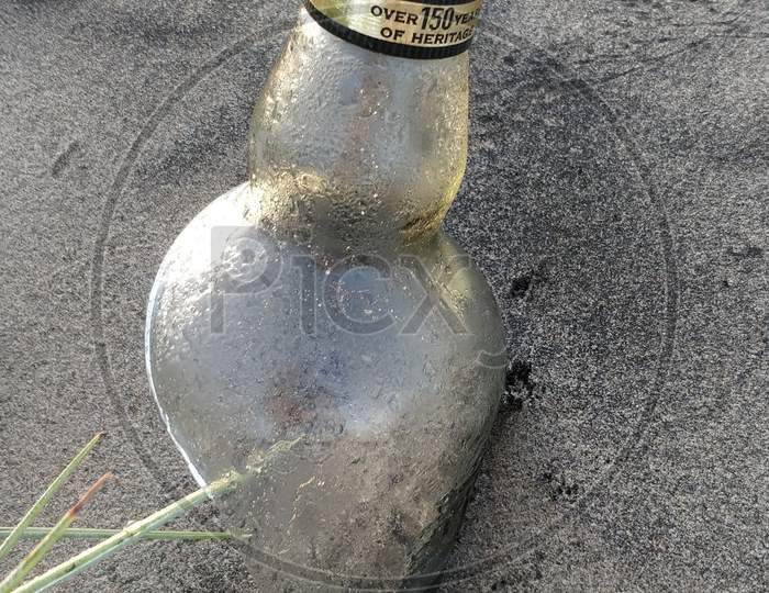 Drink bottle in sand at Perupalem Beach, Andhra Pradesh