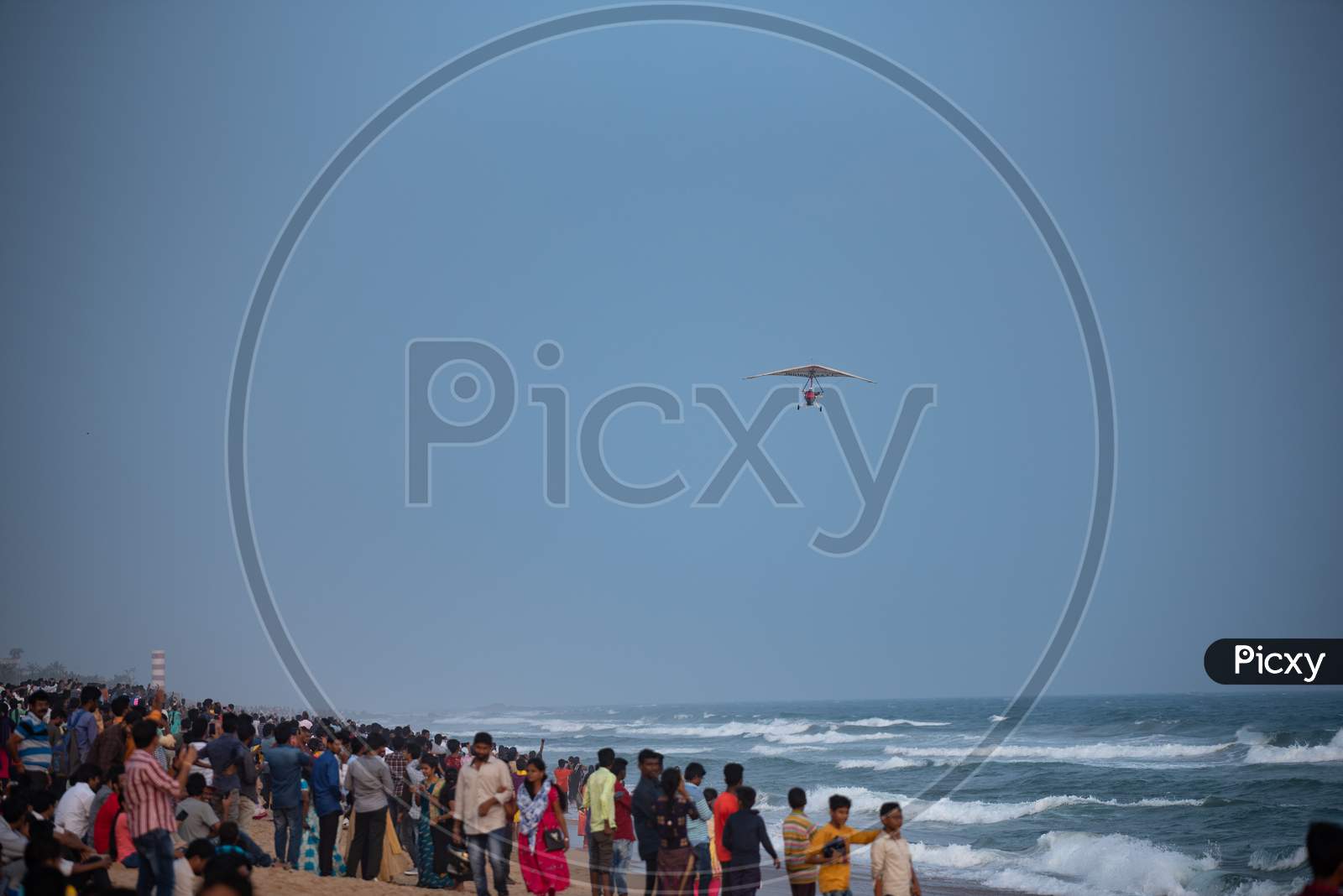 People Watching The Indian Navy Para gliders  Demonstration During Navy day Celebrations at Visakhapatanam