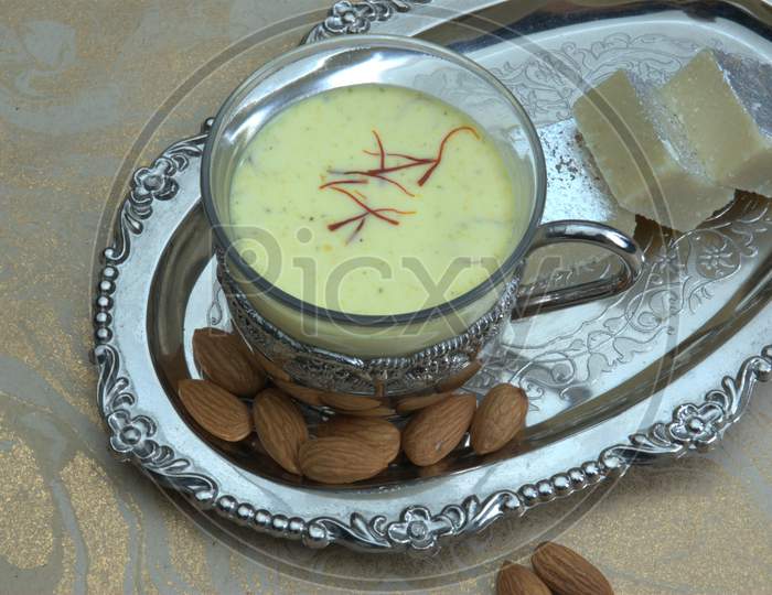 Indian Dessert Condensed Milk With Saffron and Nuts Topping Served in a Bowl