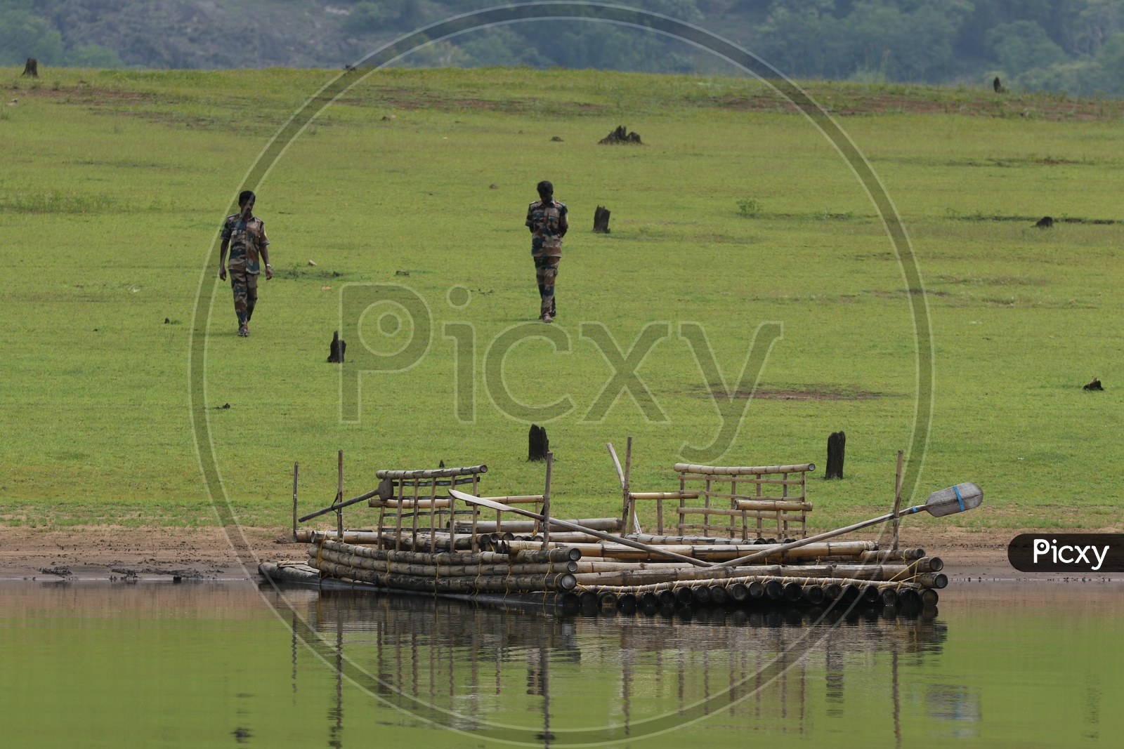 Military men and a raft in the river at Parambikulam Tiger reserve