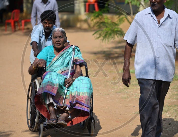 Photograph of old women on wheel chair
